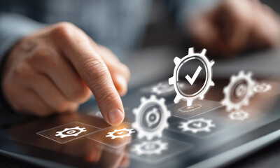 Close-up of a hand interacting with virtual gear icons on a touchscreen, symbolizing process automation, quality control, system integration and digital technology.