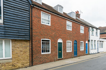 Traditional British terraced houses with colourful wooden front doors in a old city centre