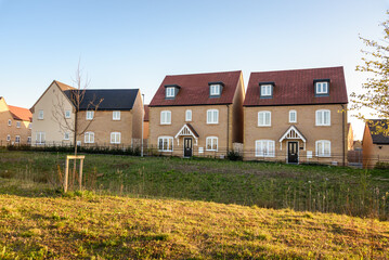 Newly built houses in a new housing developemnt on the outskirts of city in England at sunset in spring