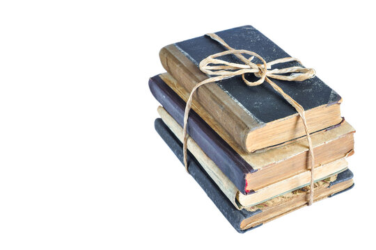 Isolated old books tied with string on white background, ancient books in pile, copy space 