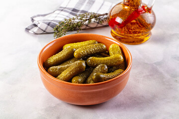 Marinated canned green cornichon cucumbers
