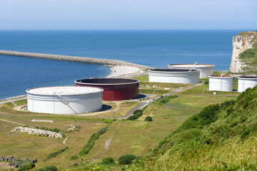 Large steel fuel tanks in a oil terminal on the coast of Normandy on a sunny summer day
