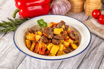 Rogiut with meat, potato and tomatoes