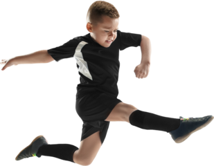 Young boy jumping to kick football in black uniform on transparent background. Concept of explosive movement, dynamic play, youth energy, physical development, and sport action.