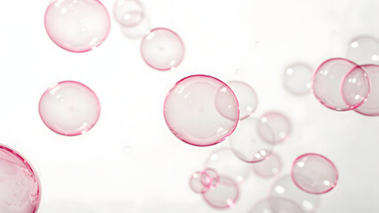 Pink, transparent bubbles against a clean white background