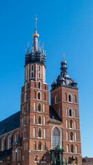 Basilica of St. Mary. Basilica with two towers of different shapes against a blue sky in front of the square