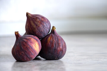 Fresh figs on the table. Fresh figs are lying on the table on grey background