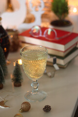 Cookie jar, tea, wine, nuts, books, lit candles and Christmas decorations on the table. Cozy...