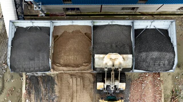 Aerial view of industrial facility with railcar containing different types of bulk material