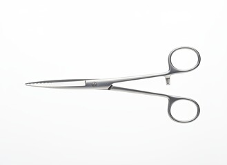 Long medical scissors with fine serrated blades on bright studio surface