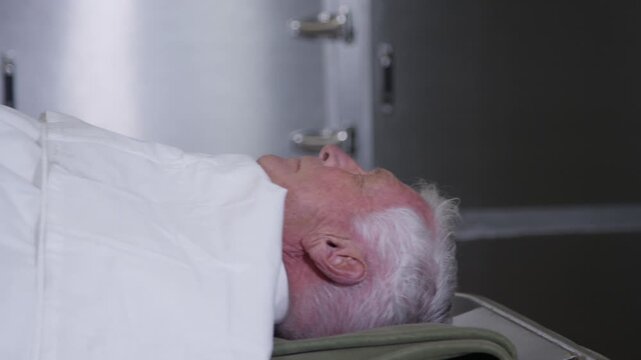 A corpse on a gurney in a hospital morgue