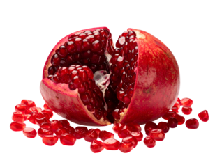 Ripe pomegranate split open with glossy red arils and scattered seeds, fresh juicy fruit food concept on isolated background