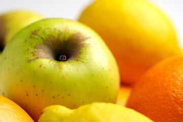 Colorful mix of whole seasonal produce with apples and citrus fruits. Wholesome lifestyle concept