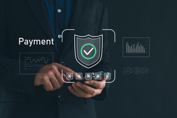 Businessman using smartphone with secure payment verification interface and shield check icon, representing online payment security, digital transaction, fintech protection, cybersecurity technology.