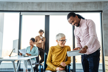 Diverse group of businesspeople discussing charts during a meeting together in a modern office