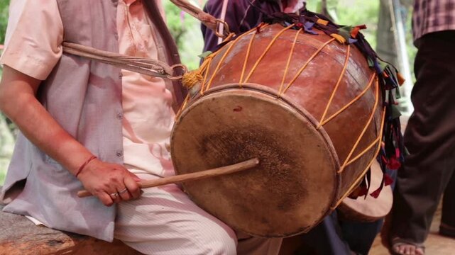 Traditional drum performance during a poor village marriage in Uttarakhand, India. Rural wedding music highlights cultural rituals, community bonding, simple lifestyle, and authentic mountain village 