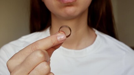 
 A woman with a wedding ring and a broken heart after a breakup.Letting go of past love.