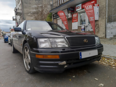 Polska, Ostrowiec Świętokrzyski, 27 października 2025, 16:18. Czarna, klasyczna japońska limuzyna LEXUS zaparkowana na ulicy. Samoch&oacute;d charakteryzuje się eleganckim wyglądem z wyrazistym grillem 