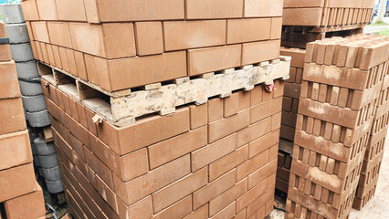 Stacked concrete bricks with hollow cores at a construction site, showing raw texture and earthy tones, representing building materials, industrial manufacturing, and infrastructure development.