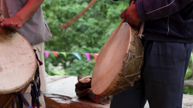 Village men play traditional drums during a poor rural wedding in Uttarakhand, India. The scene reflects poverty, folk music, community participation, and mountain village marriage traditions.