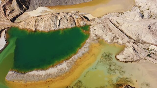 Waste rock dumps, artificial lakes in ilmenite quarry, aerial view