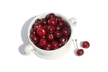 There is a pile of ripe juicy cherries on the plate.	