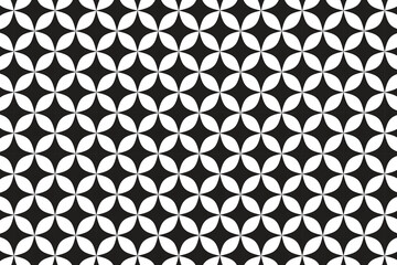 This high-contrast geometric pattern features a repeating tessellation of black and white shapes. The design consists of interlocking four-petaled elements that resemble stylized flowers or quatrefoil © Dipankar