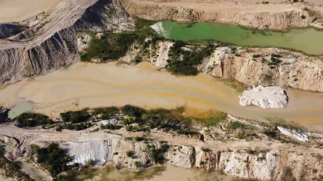 Waste rock dumps, artificial lakes in ilmenite quarry, aerial view