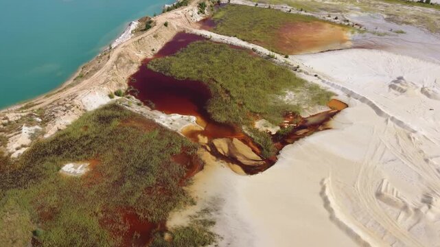 Waste rock dumps, artificial lakes in ilmenite quarry, aerial view