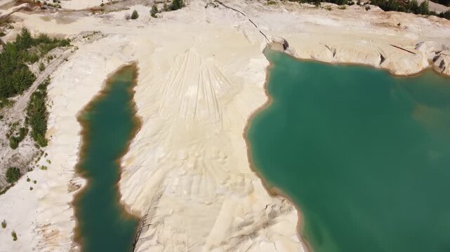 Waste rock dumps, artificial lakes in ilmenite quarry, aerial view