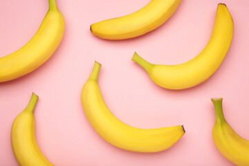 Yellow bananas flat lay on pink background.