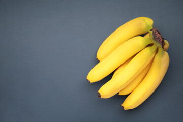 Bunch of bananas on dark blue background. Top view