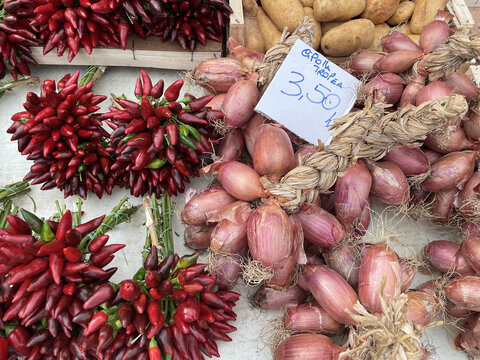 Chilies and shallots sold on a market in Andrano, Italy