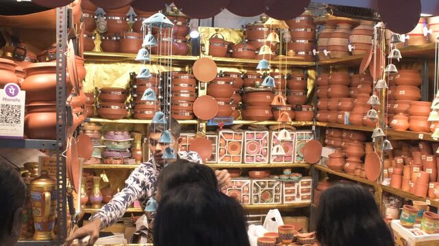 busy terracotta pottery and clay utensils stall during india international mega trade fair