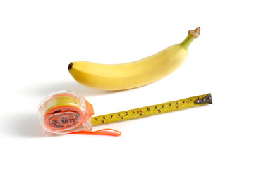 There is a banana with a construction tape measure on a white background.