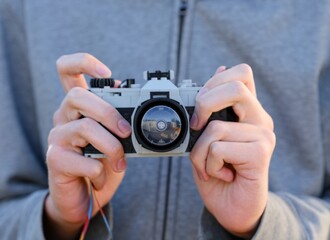 Naklejka premium Tambov, Russian Federation - October 01, 2025 Close-up of person with Lego camera in his hands