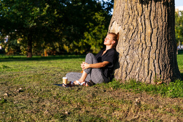Serene woman enjoying mindful pause in city park.