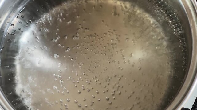 Water begin to boil in stainless steel pot