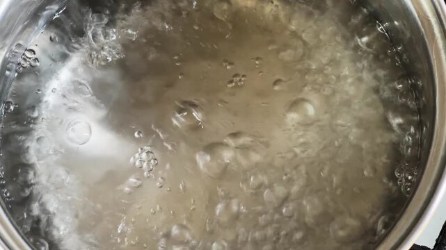 Water in stainless steel pot during the boiling