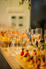 Guests enjoy a lively gathering filled with sparkling drinks and vibrant fruits on elegant tables