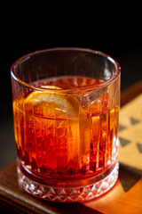 A stunning cocktail with rich colors sits on a wooden surface, inviting enjoyment and relaxation
