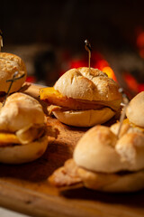 Macro close-up of a traditional pork leg sandwich with Serra cheese and grilled pineapple on rustic bread.