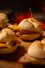 Macro close-up of a traditional pork leg sandwich with Serra cheese and grilled pineapple on rustic bread.