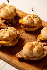 Macro close-up of a traditional pork leg sandwich with Serra cheese and grilled pineapple on rustic bread.