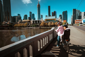 Biking along the river while enjoying the stunning views of the city skyline in Melbourne