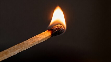 burning match on dark background
