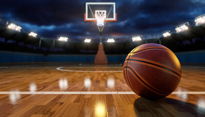 Basketball court with a basketball in the foreground under stadium lights during a game
