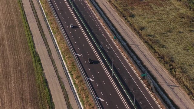 A1 highway from Bucharest to Pitesit Curtea de Arges and Sibiu 4K video. Newly built A1 Highway in Romania, cutting through rural fields and valleys, with mountains visible in the distance.
