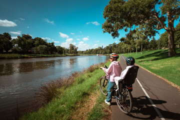 Im enjoying a beautiful bike ride along a serene riverbank, soaking in the sights
