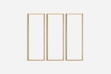 Frame mockup 1:3. Set of three thin cherry wood frames. Gallery wall mockup, set of 3 frames. Clean, modern, minimalist, bright. Portrait. Vertical.